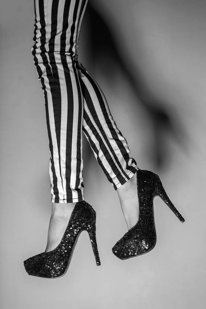 Sexy legs on gray background, black and white - Fotó, kép