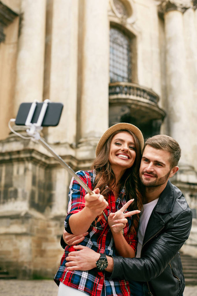 Lovely Tourist Couple Taking Photos On Phone On Street - Valokuva, kuva