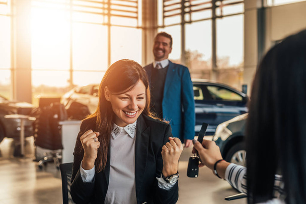 woman receives the keys to a new car  - Фото, изображение