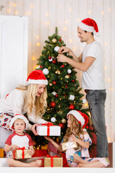 Happy family decorates Christmas pine - Фото, изображение