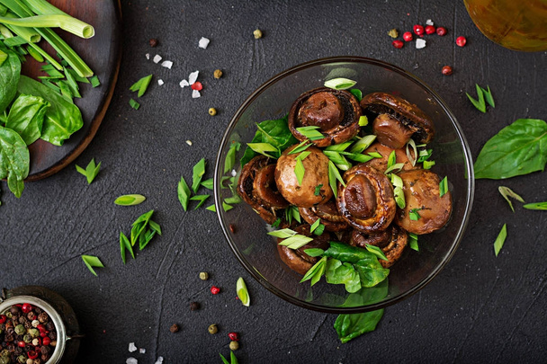 Baked mushrooms with soy sauce and herbs in glass bowl  - Photo, Image