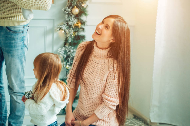 Happy father, mother and daughter preparing for Christmas - Фото, зображення