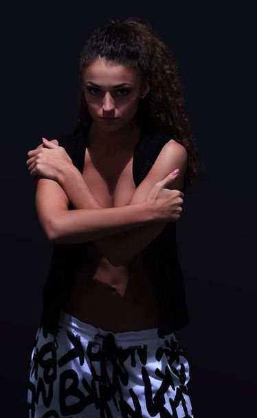 young woman dancing hip-hop in studio. - Foto, afbeelding