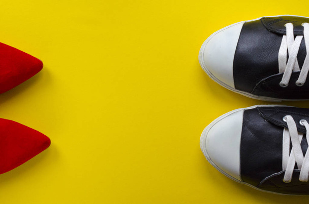  two pairs of shoes opposite  on yellow background - Photo, Image