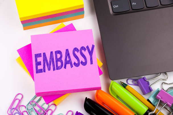 Writing text showing Embassy made in the office with surroundings such as laptop, marker, pen. Business concept for Tourist Visa Application Workshop white background copy space - Photo, Image