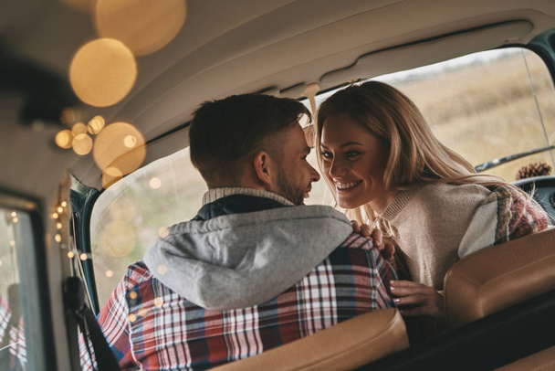 flirting beautiful couple in love enjoying travel in vintage car - Valokuva, kuva