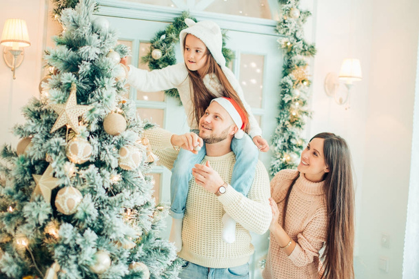 happy girl decorating Christmas tree.Family, christmas, ,happiness concept - Fotó, kép