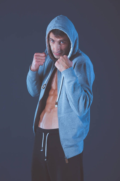 Profile view of young man practicing boxing .Personal instructor. Personal training. - Foto, Imagem