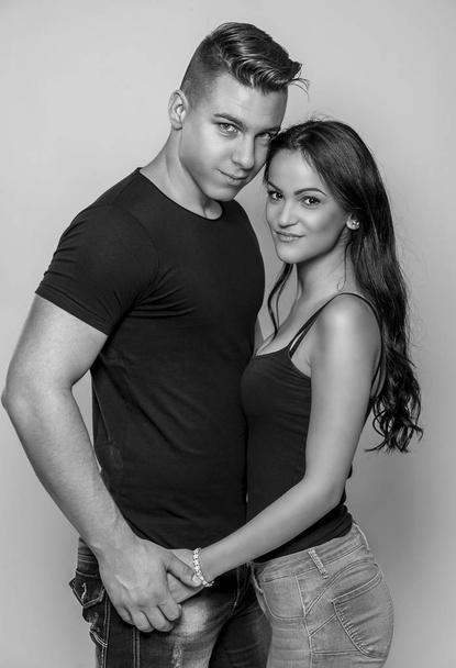 Black and white fashion studio photo of beautiful couple, wears elegant clothes, embracing each other - 写真・画像
