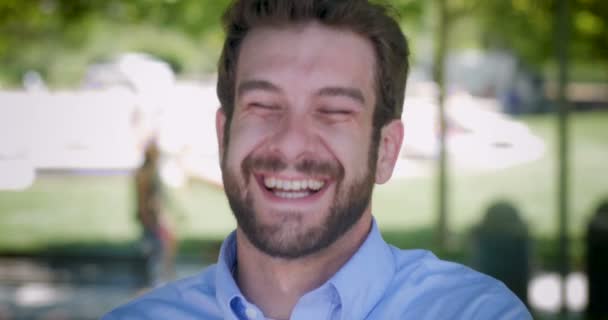 Attractive millennial man in 30s with beard laughing out loud - Filmagem, Vídeo