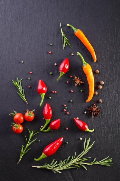 Different spices with tomato and  peppers on a black background - Foto, Imagen
