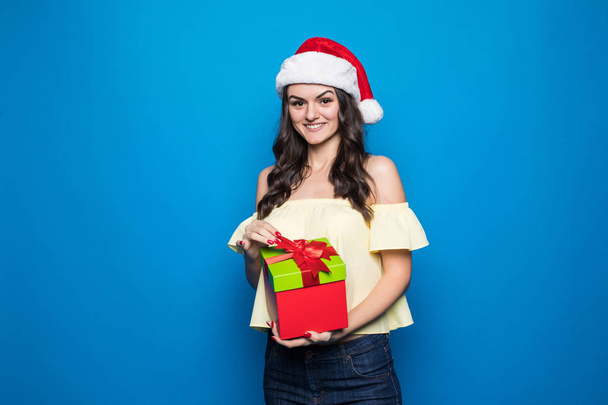 christmas, holidays, celebration and people concept - smiling woman in red dress with gift boxes over blue background - Φωτογραφία, εικόνα