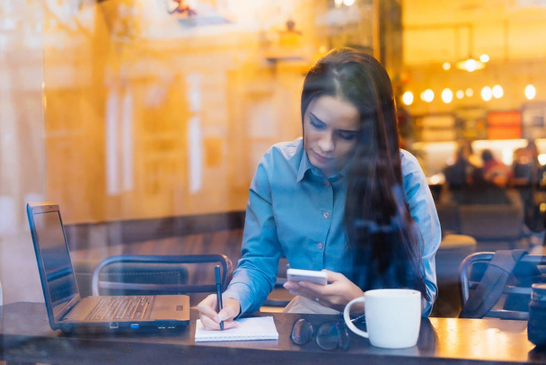 busy business woman working at a cafe, with laptop - Zdjęcie, obraz