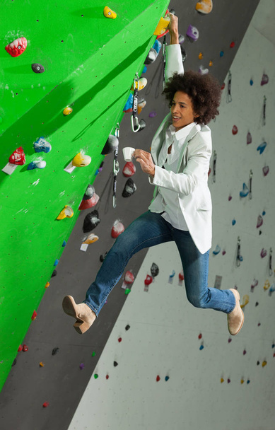 woman on artificial climbing wall  - Фото, изображение