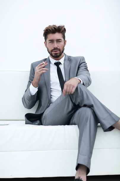 Portrait of a businessman in a suit with a cigarette - Fotoğraf, Görsel