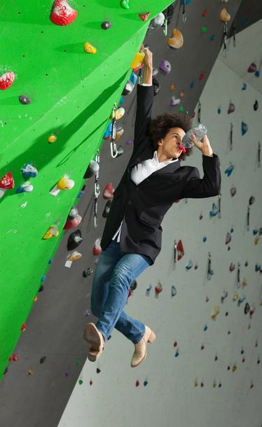 woman on artificial climbing wall  - Foto, Imagen