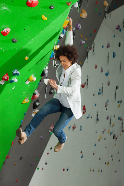 woman on artificial climbing wall  - Фото, зображення