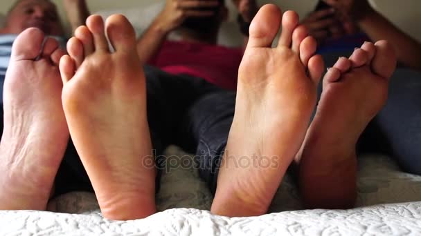 Οικογενειακή διασκέδαση έχοντας τα πόδια στο κρεβάτι - Πλάνα, βίντεο