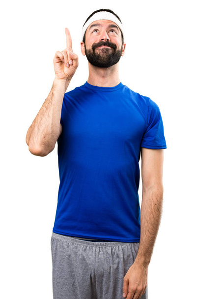 Funny sportsman pointing up on isolated white background - Φωτογραφία, εικόνα