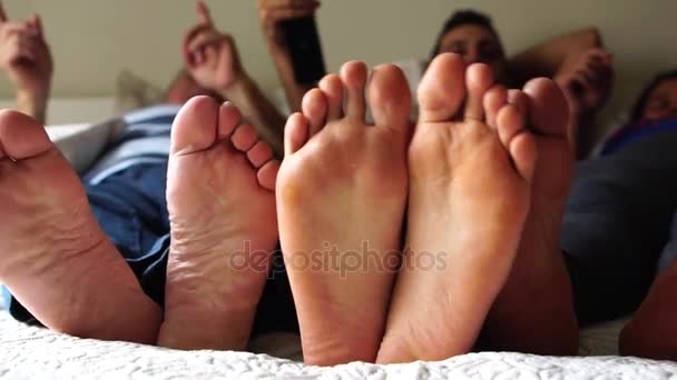 Rodzina zabawy nogi na łóżku - Materiał filmowy, wideo
