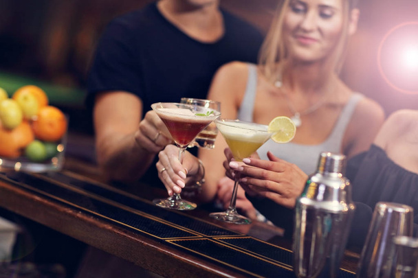 Group Of Friends Enjoying Drink in Bar - Фото, изображение