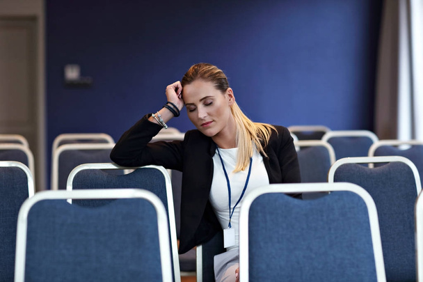 Young woman sitting alone in conference room - Φωτογραφία, εικόνα