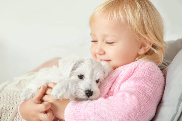 Little cute girl with puppy  - Zdjęcie, obraz