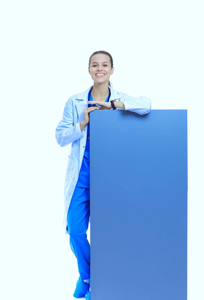 A female doctor with a blank billboard. Woman doctor - Φωτογραφία, εικόνα