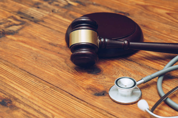 Stethoscope with judge gavel. Concept of healthcare and medicine, malpractice, legal system. - Foto, imagen