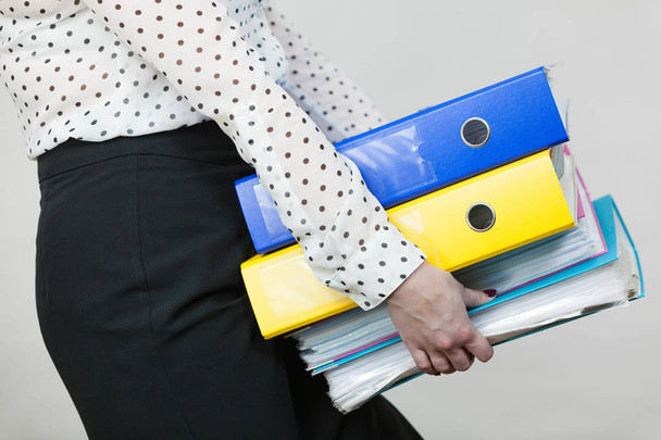 Woman holding heavy colorful binders with documents - Foto, Imagem