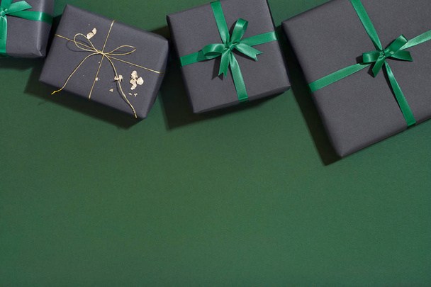 Christmas gift boxes on green background, xmas present flat lay - Photo, Image