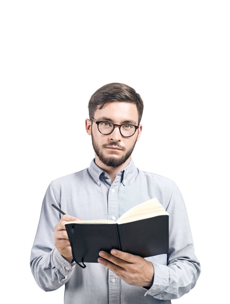 Intelligent young man with a planner, isolated - Foto, Imagen