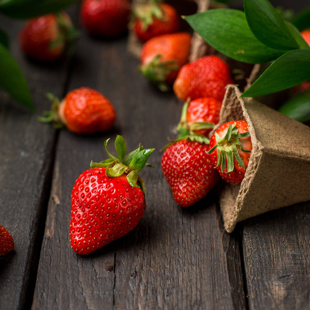 Fresh strawberries on a wooden vintage background. Place for text - Photo, Image