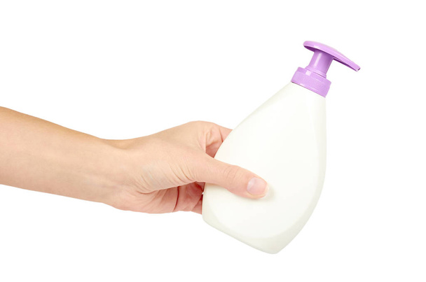White hand sanitizer soap dispenser in hand isolated on white background. Housework and sanitary concept - Foto, Imagen