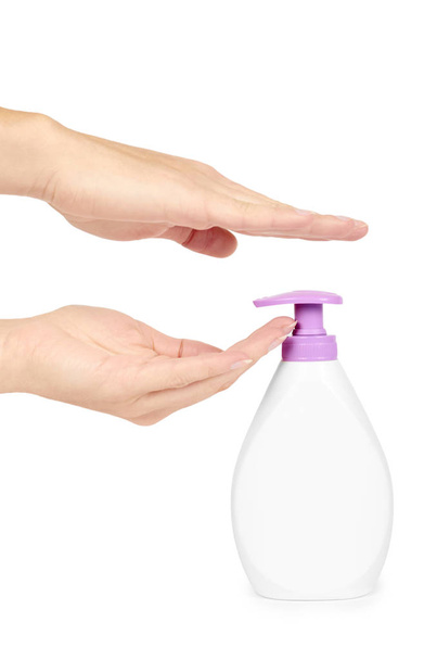 White hand sanitizer soap dispenser in hand isolated on white background. Housework and sanitary concept - Fotoğraf, Görsel