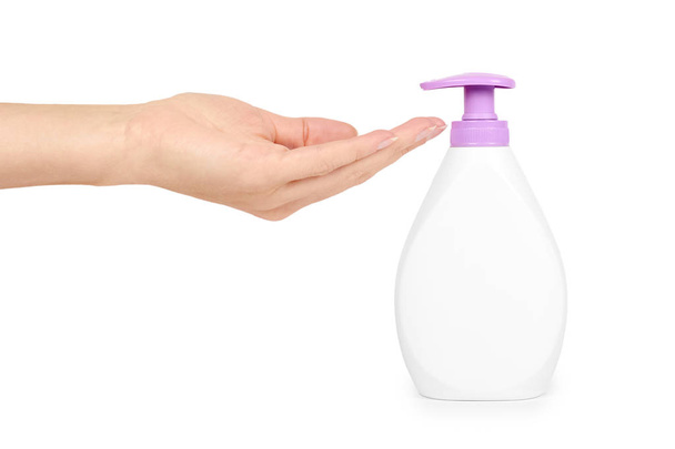 White hand sanitizer soap dispenser in hand isolated on white background. Housework and sanitary concept - Photo, image