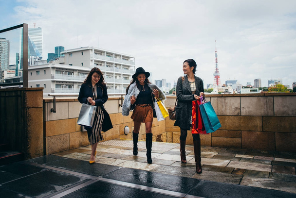 Group of japanese women spending time in Tokyo, making shopping  - Photo, image