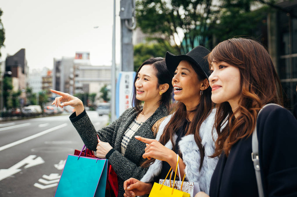 Group of japanese women spending time in Tokyo, making shopping  - 写真・画像
