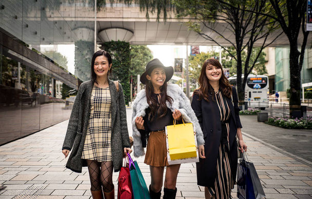 Group of japanese women spending time in Tokyo, making shopping  - Photo, Image
