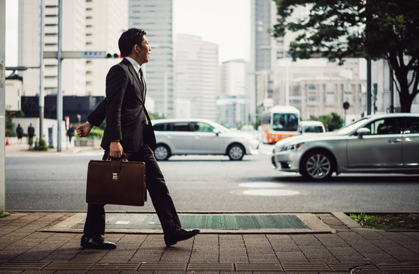 Senior business man moments on the streets of Tokyo - Photo, Image