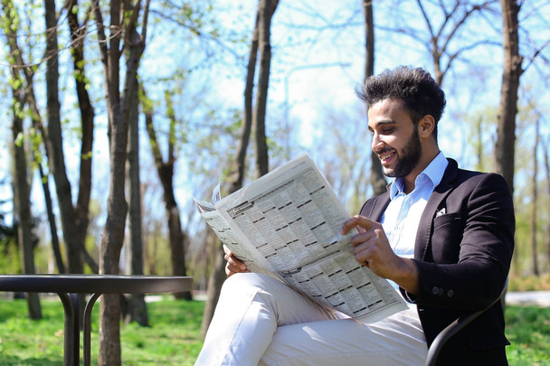 Mulatto gars lecture journal dans caf et sourires
. - Photo, image