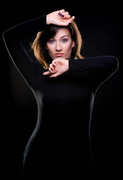 Portrait of a beautiful woman in black - Photo, image