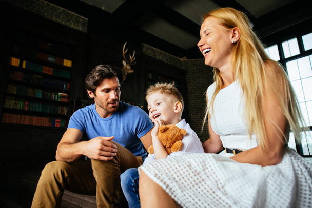 Family home portrait. Parents and son spending time together - Фото, изображение