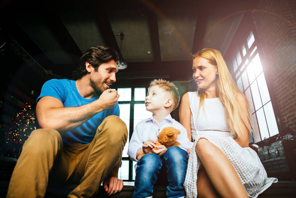 Family home portrait. Parents and son spending time together - Photo, Image