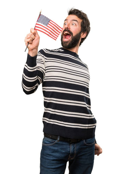Man with beard holding an american flag - Photo, image