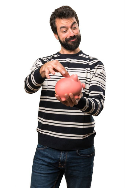 Man met baard houden een spaarpot - Foto, afbeelding