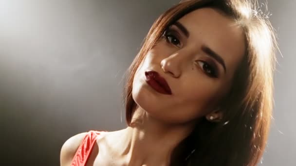 Portrait of beautiful female model on black background - Video, Çekim