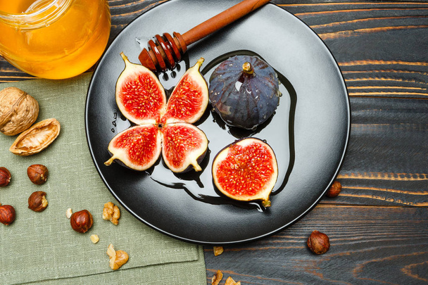 Fig isolated on wooden background - 写真・画像