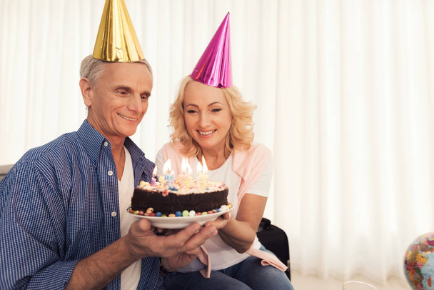 Birthday of the elderly person. People in a birthday hats. Elderly people celebrate birthday. - Foto, Bild
