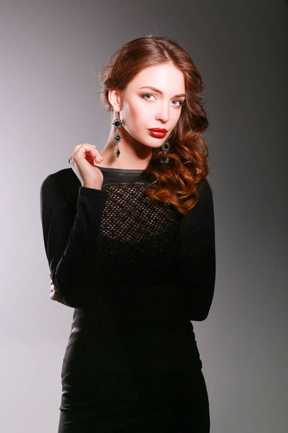 Beautiful woman with evening make-up in black dress - Photo, Image